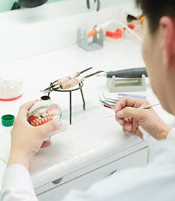 a dental lab technician crafting dentures