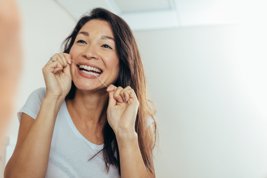 closeup of person flossing